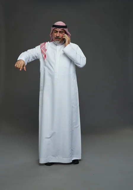 Elderly Saudi Man Talking on Mobile Phone in Studio