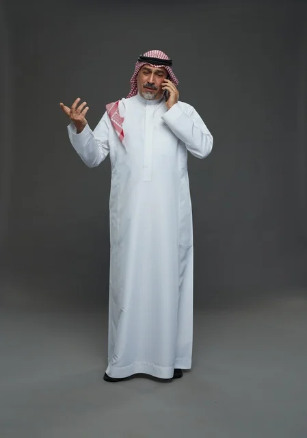 Elderly Saudi Man Talking on Smartphone in Studio