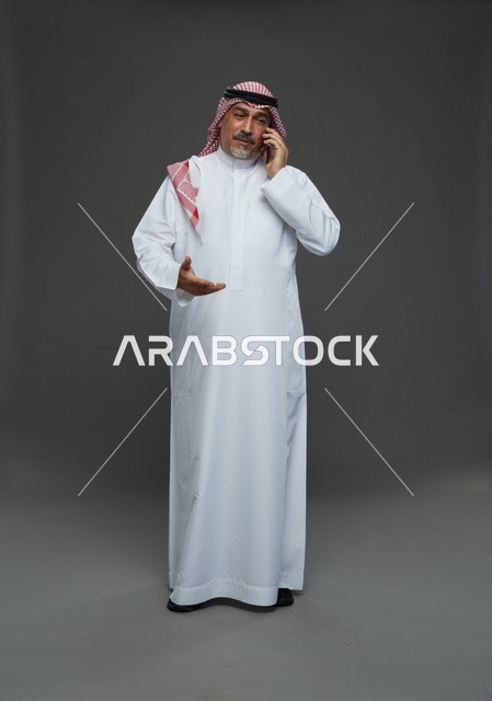 Elderly Saudi Man Smiling While Talking on Mobile Phone