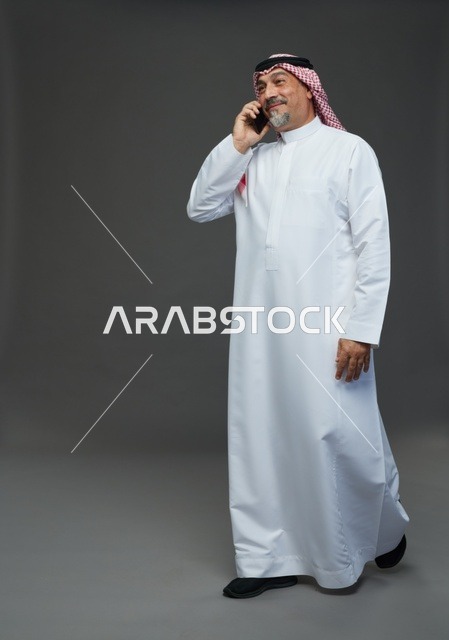 Elderly Saudi Man Talking on Mobile Phone Studio Shot