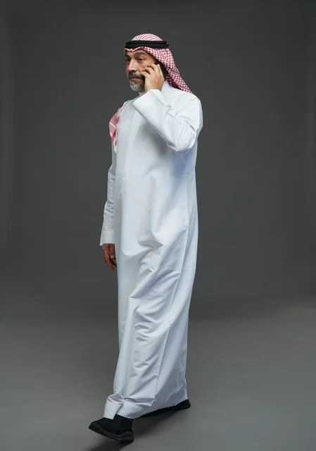 Elderly Saudi Man Talking on Smartphone in Studio