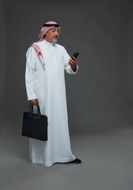 Saudi Businessman with Briefcase and Smartphone Studio