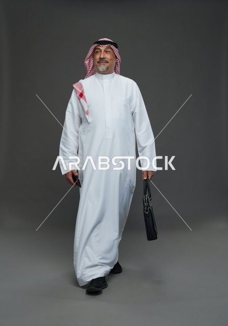 Elderly Saudi Businessman Walking with Briefcase