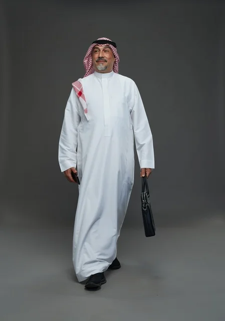 Elderly Saudi Businessman Walking with Briefcase