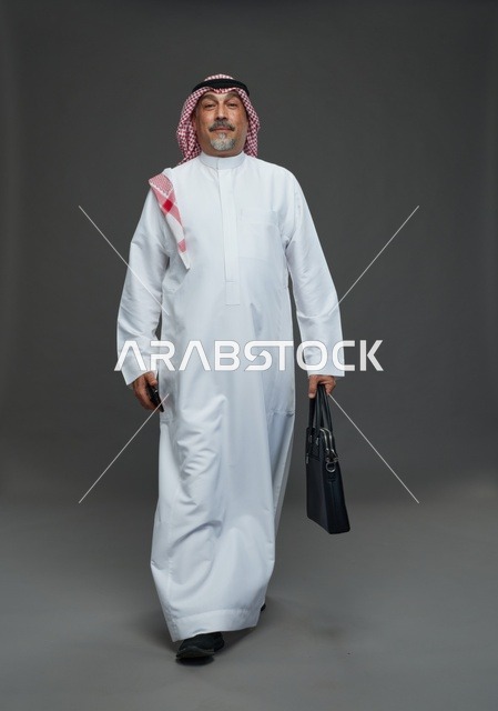 Saudi Businessman Walking with Briefcase on Grey Background