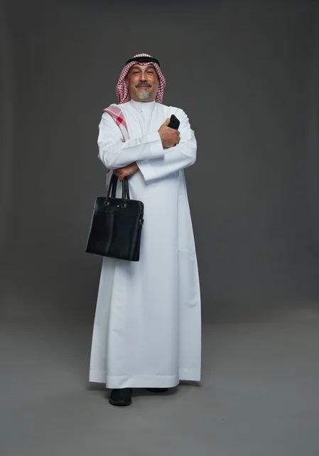 Saudi Businessman Holding Briefcase and Smartphone