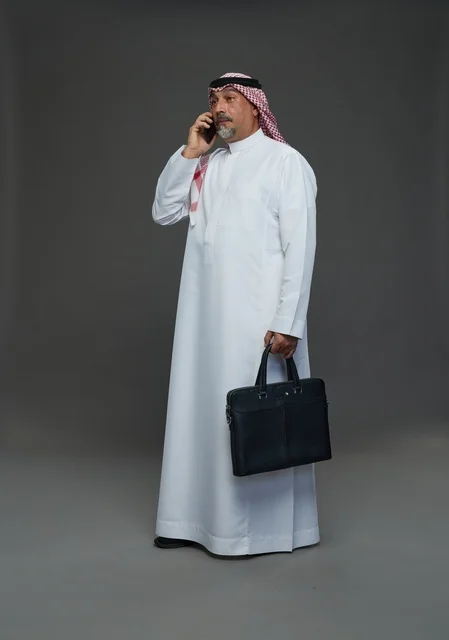 Saudi Businessman with Briefcase Talking on Mobile Phone