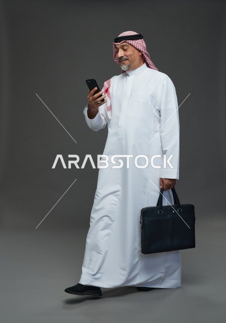 Saudi Businessman with Mobile Phone and Briefcase