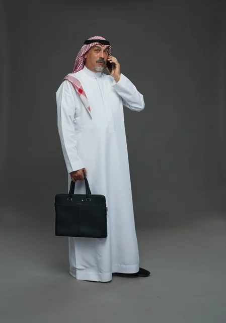 Elderly Saudi Businessman with Briefcase and Phone