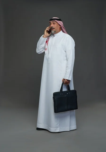 Saudi Businessman Talking on Phone with Briefcase