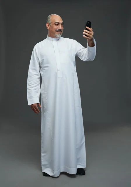 Senior Saudi Man Using Smartphone in Studio