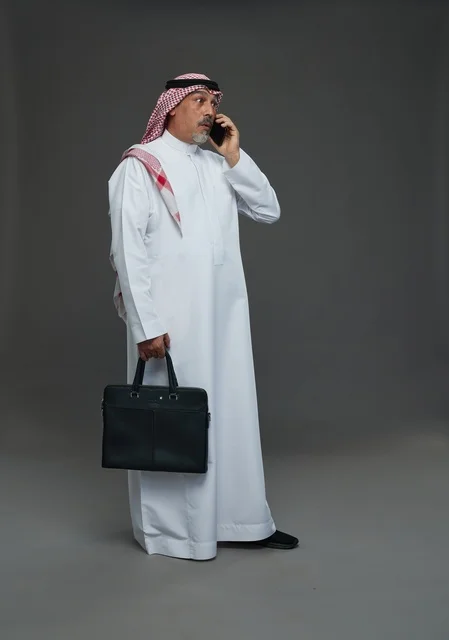 Saudi Businessman with Briefcase Talking on Smartphone