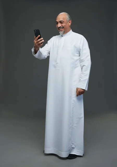 Senior Saudi Man Using Smartphone in Studio