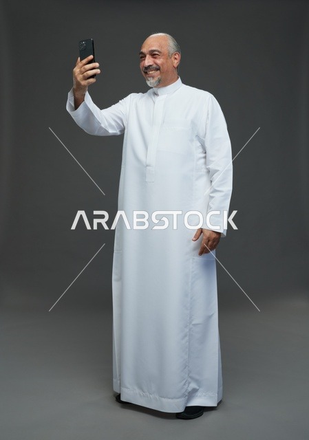 Elderly Saudi Man Taking Selfie with Smartphone