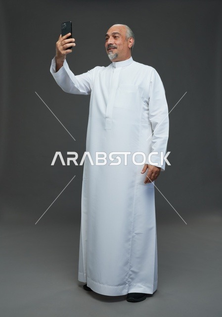 Elderly Saudi Man Taking Selfie in Traditional Thobe