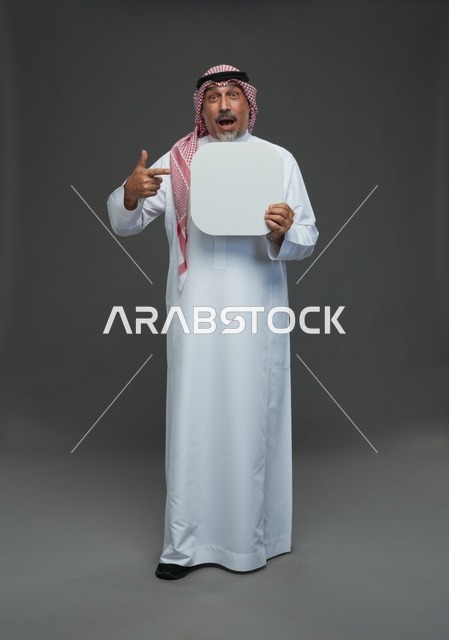 رجل سعودي مسن يحمل لوحة إعلانية بيضاء فارغة