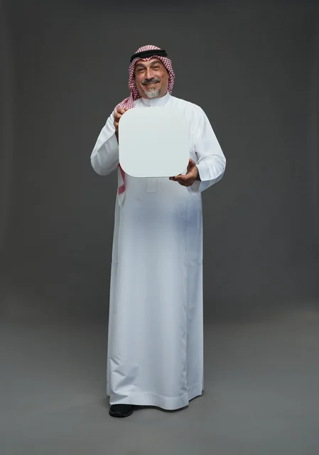 Elderly Saudi Man Holding Blank Sign on Grey Background