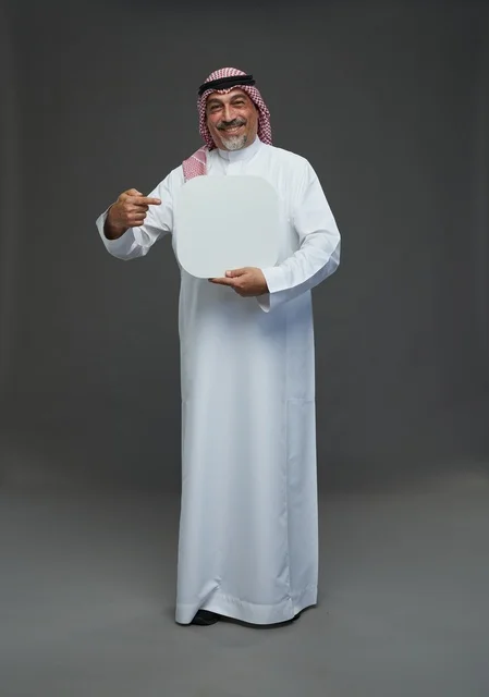 Elderly Saudi Man Holding Blank Signboard on Grey Background