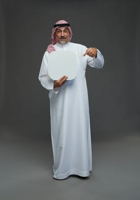 Elderly Saudi Man Holding Blank Board in Studio