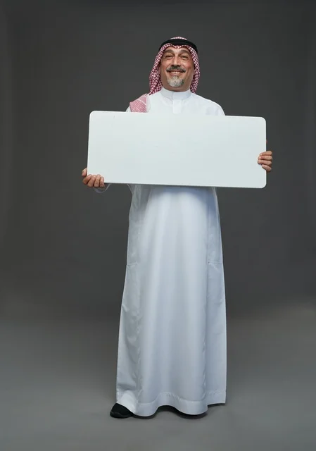 Elderly Saudi Man Holding Blank White Signboard in Studio