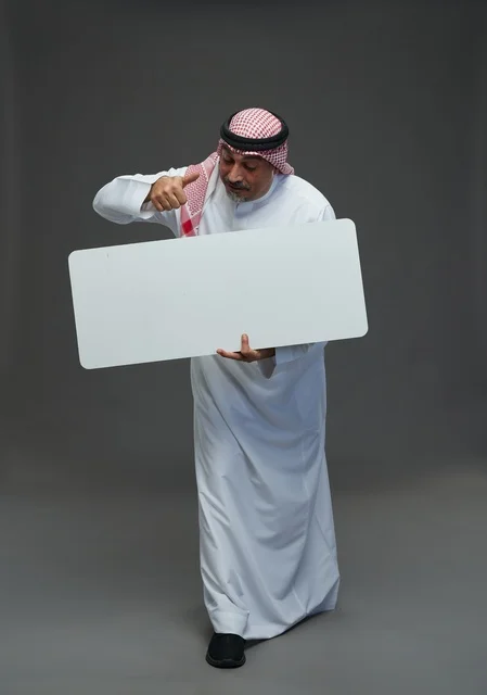 Senior Saudi Man with Blank Signboard and Thumbs Up