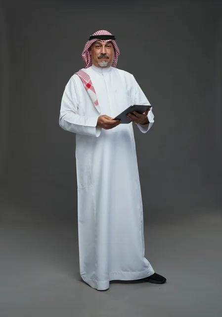 Elderly Saudi Man Using Tablet in Studio