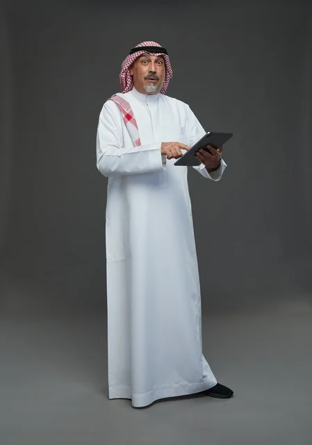 Elderly Saudi man using a tablet device