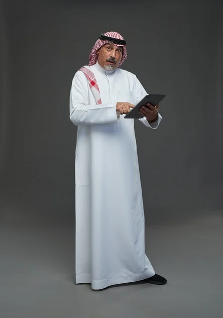 Elderly Saudi Man Using Tablet in Studio Portrait
