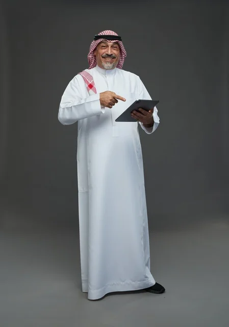 Elderly Saudi Man Using Digital Tablet in Studio