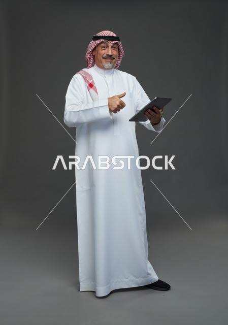Elderly Saudi Man Using Tablet with Thumbs Up