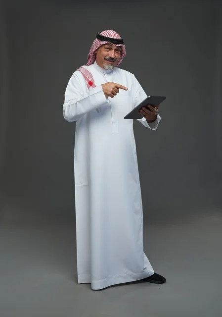 Elderly Saudi Man Using Digital Tablet in Studio
