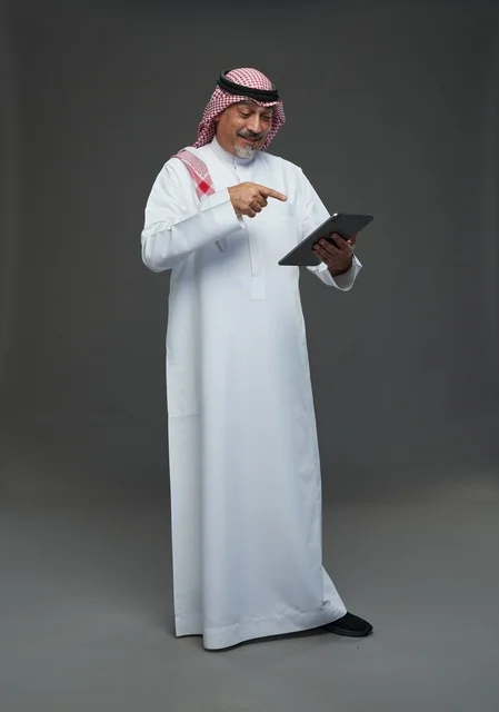 Senior Saudi Man Using Digital Tablet in Studio