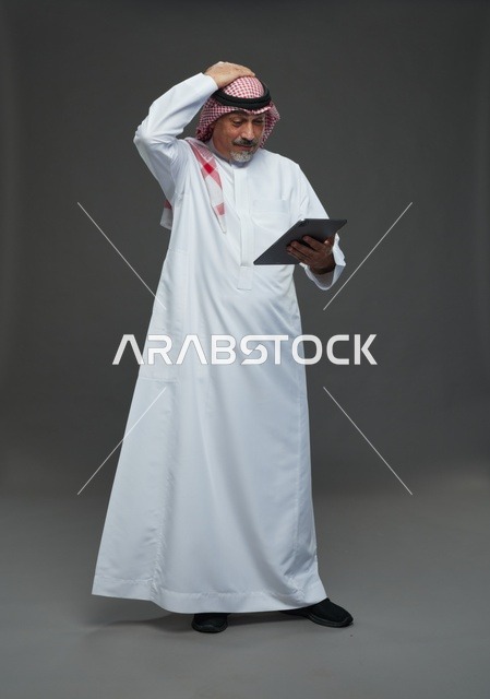 Elderly Saudi Man Using Tablet in Studio