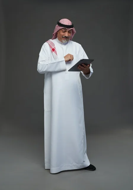 Senior Saudi Man Using Tablet in Studio