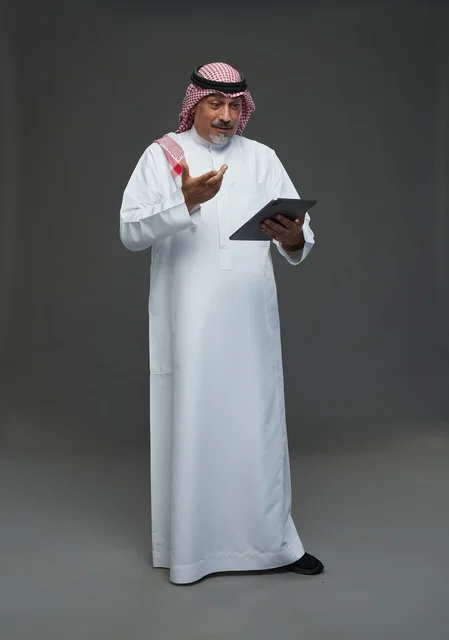 Elderly Saudi Man Using Digital Tablet in Studio