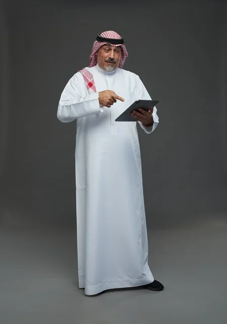 Elderly Saudi man using a tablet device