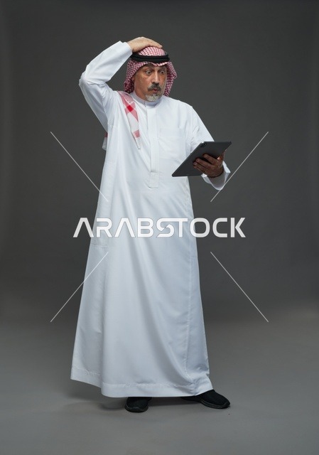 Elderly Saudi man using a tablet device