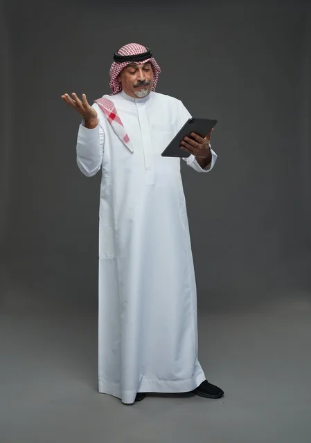 Senior Saudi Man Using Digital Tablet in Studio