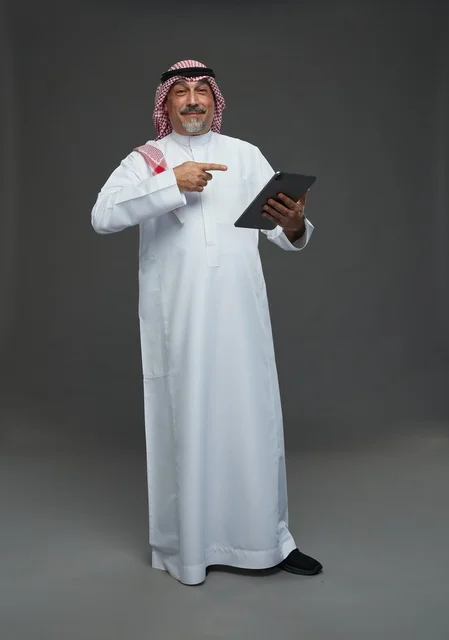 Elderly Saudi Man Using Digital Tablet in Studio