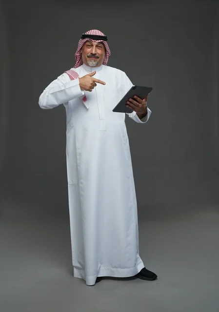 Elderly Saudi Man Using Tablet in Studio
