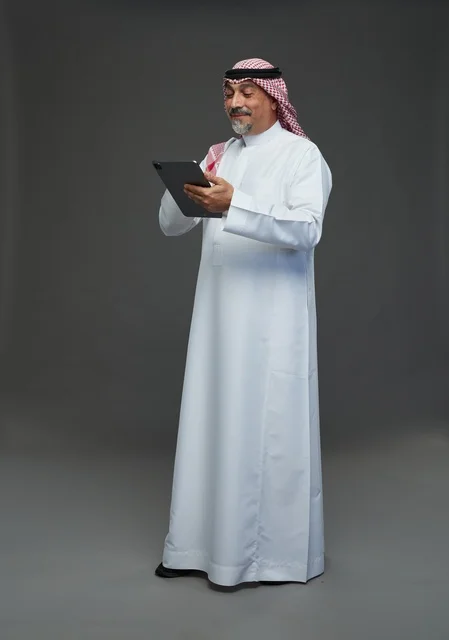 Elderly Saudi Man Using Digital Tablet in Studio