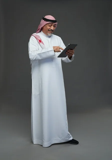 Elderly Saudi Man Using Tablet in Studio