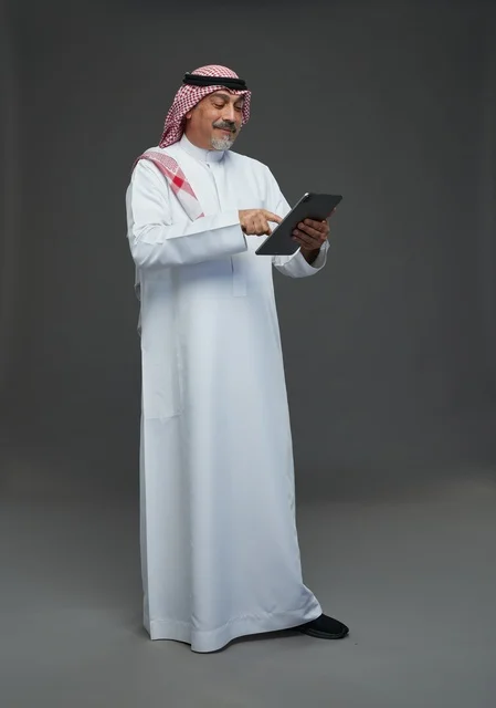 Elderly Saudi man using a tablet device