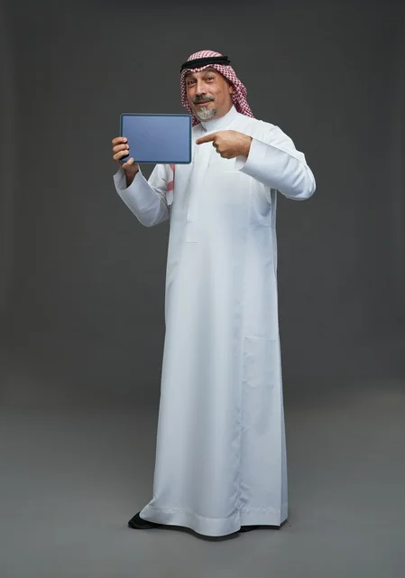 Elderly Saudi Man Pointing at Tablet in Studio