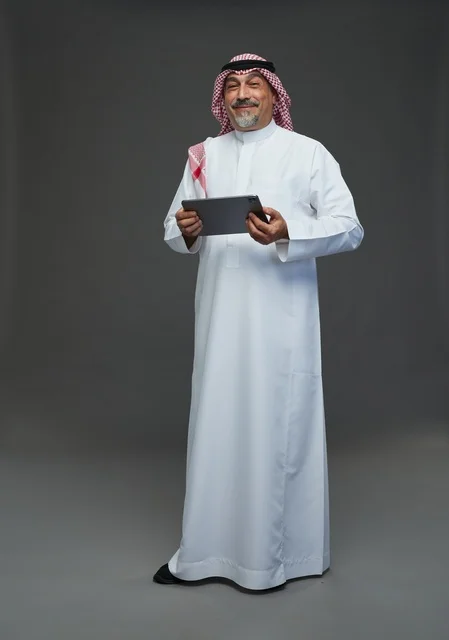 Elderly Saudi Man Using Digital Tablet in Studio Portrait