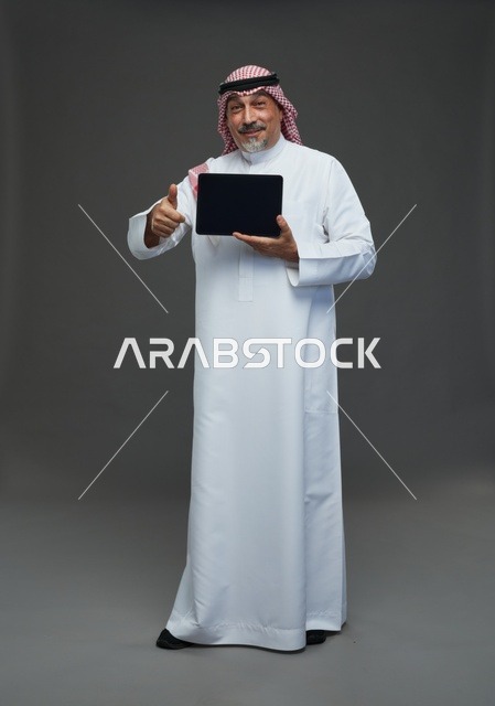 Elderly Saudi Man Holding Tablet with Thumbs Up