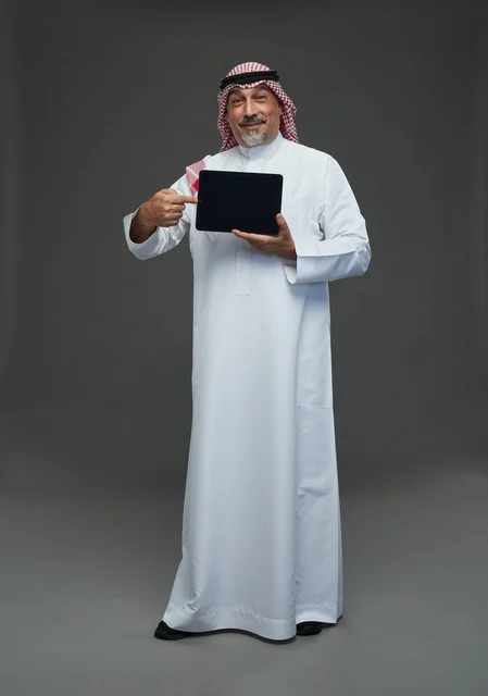 Senior Saudi Man Pointing at Tablet Blank Screen