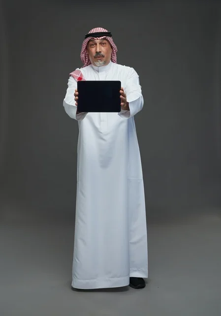 Elderly Saudi Man Holding Digital Tablet in Studio