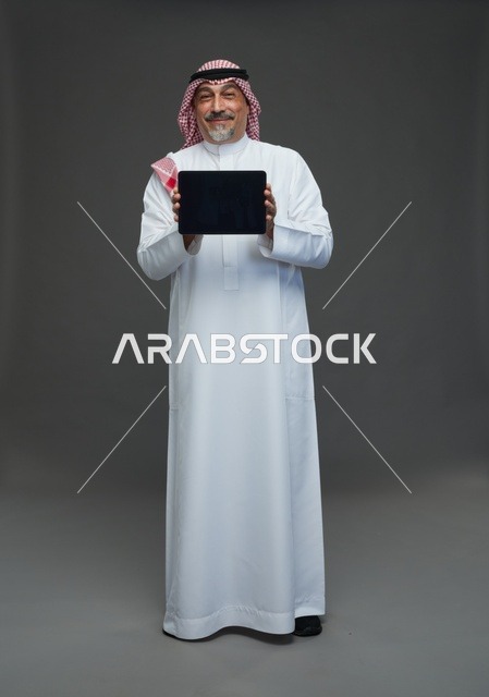 Elderly Saudi Man Holding Tablet in Studio