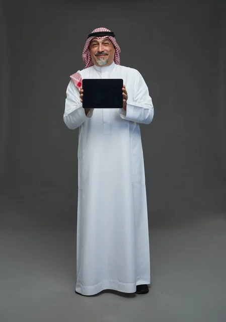 Elderly Saudi Man Holding Tablet in Studio